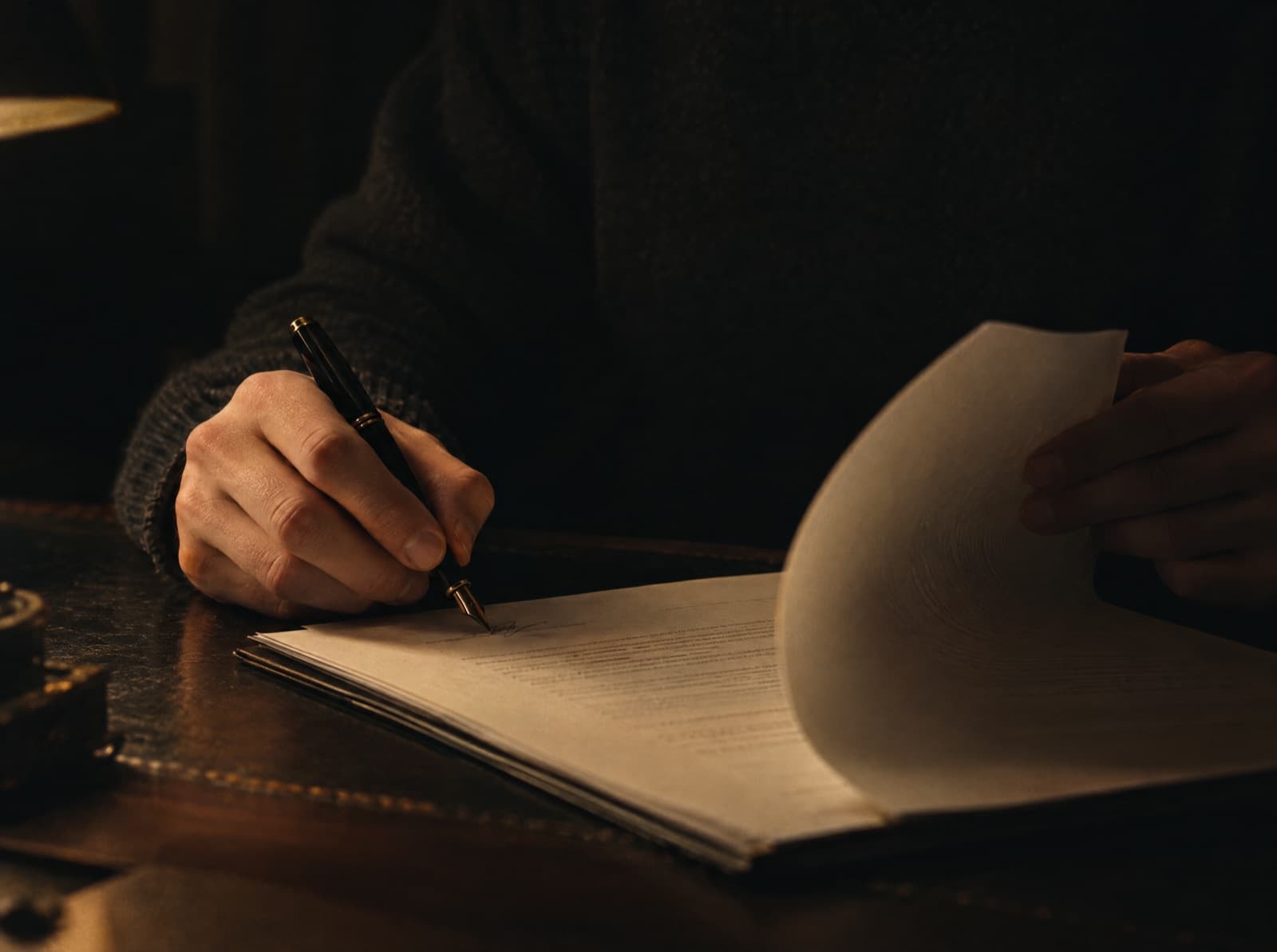 Signing the final page of a tax return with a fountain pen